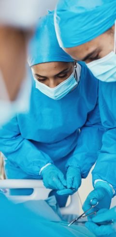 Surgery, medical operation and doctors with patient in emergency room at hospital, medic center or